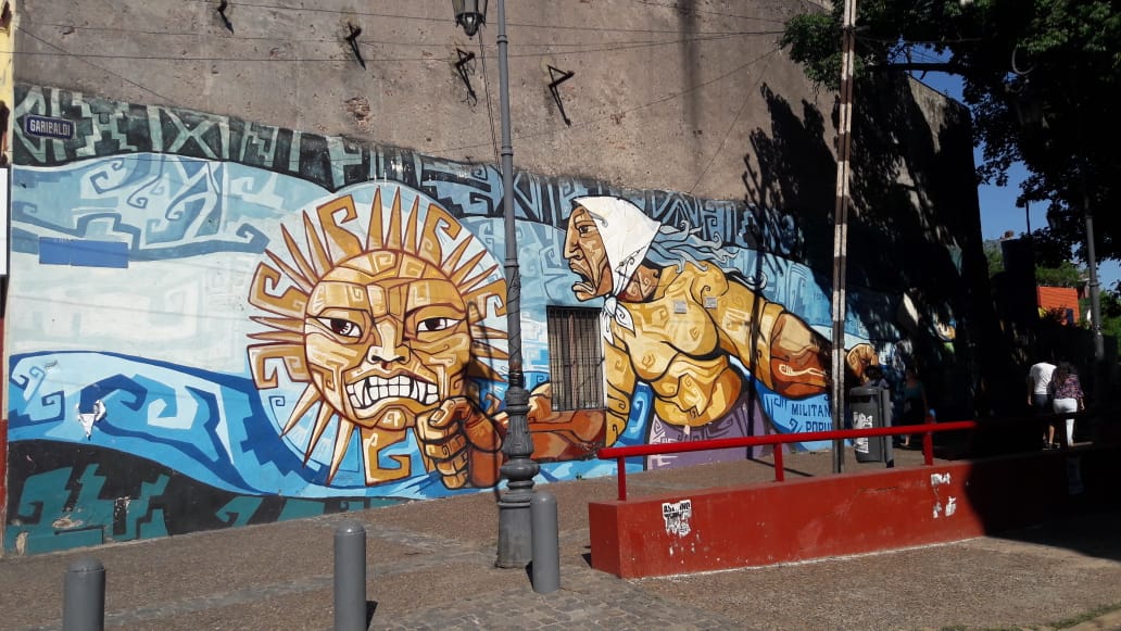 Graffiti showing a resistant woman resembling Saturday mothers and a sun with a human face and resistant expression.